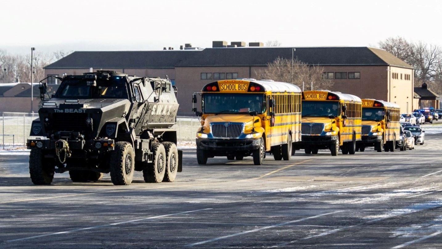 Lorain Police armored vehicle escorting school buses